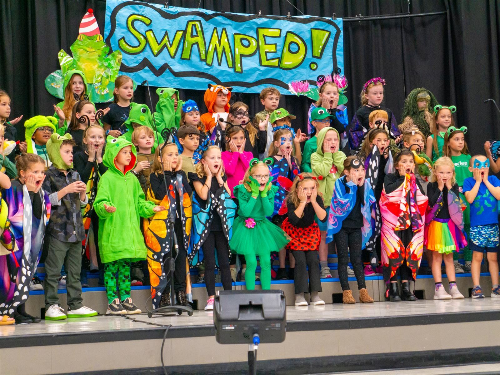 students dressed as insects singing in a choir